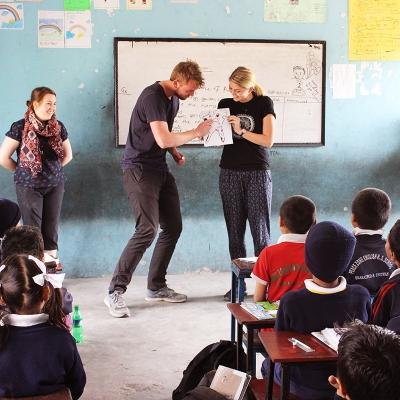 Two volunteers teaching a hygiene class to students in Nepal. Projects Abroad volunteers run a dental hygiene class at our volunteer teaching placements in Nepal.